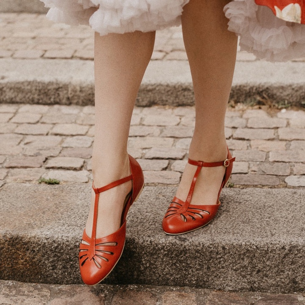 Red flat with strap. Only worn once.